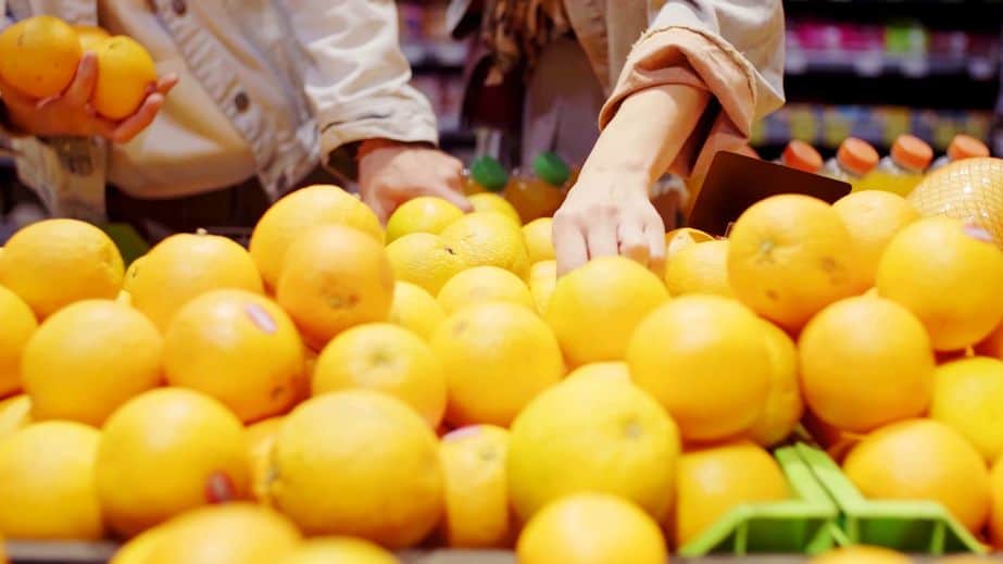 oranges piled up in a supermarket