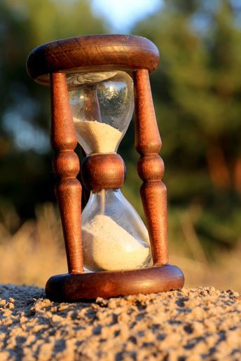 hourglass sitting on sand